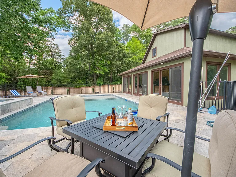 Pool, fire table and pool house.