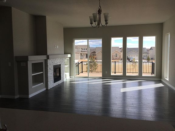 Open concept living area and deck overlooks green belt
