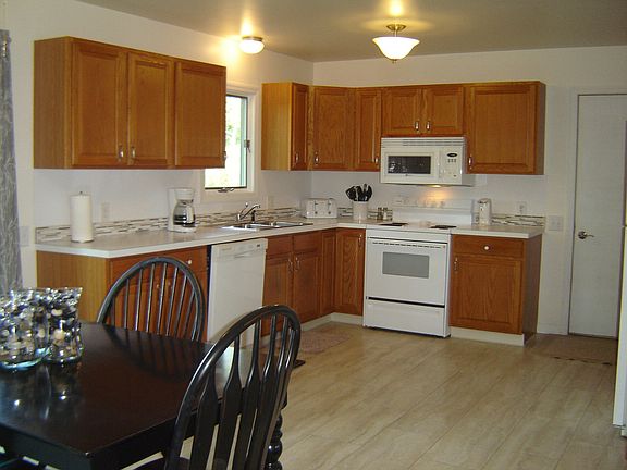 The spacious and comfortable kitchen and dining area provide the focus for family activities and a "gathering" room that will host mealtimes to homework.  The easy- care laminate floors are new.