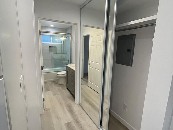 Hallway with closet leading to Bathroom and Bedroom