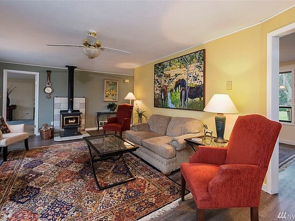 Enter the living room from the deck through sliding glass doors.  Laminate flooring.  Wood stove.