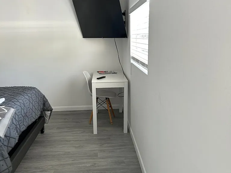 Smart TV, work desk & comfy chair for study or remote work.