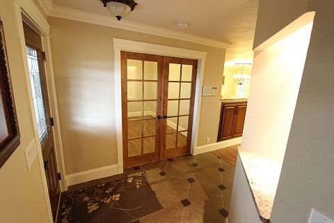 Entry with lighted plant shelf and double door to study