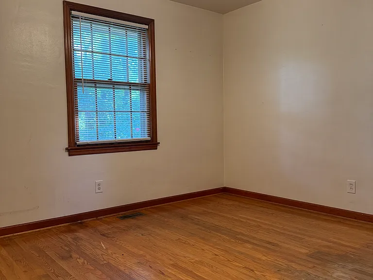 Main Level Master Bedroom with ceiling fan. This window overlooks the side yard.