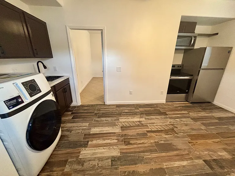 Kitchen dining area. Room is big enough to fit a table, couch TV area. In washer/dryer included. New microwave and new stove new fridge.