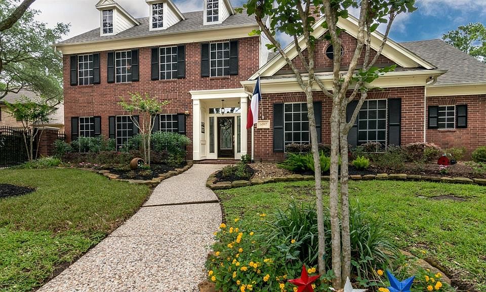 Ideal curb appeal, traditional brick has shutters and dormers.