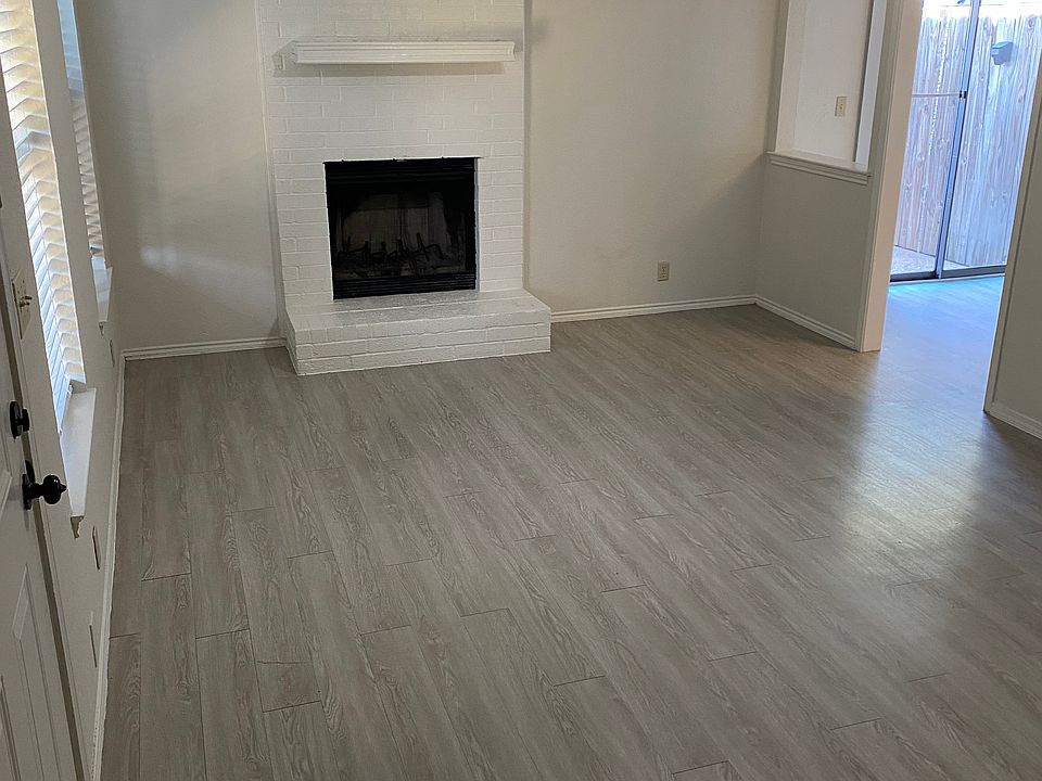 Living Area with wood burning fireplace and ceiling fan. Lots of natural light.