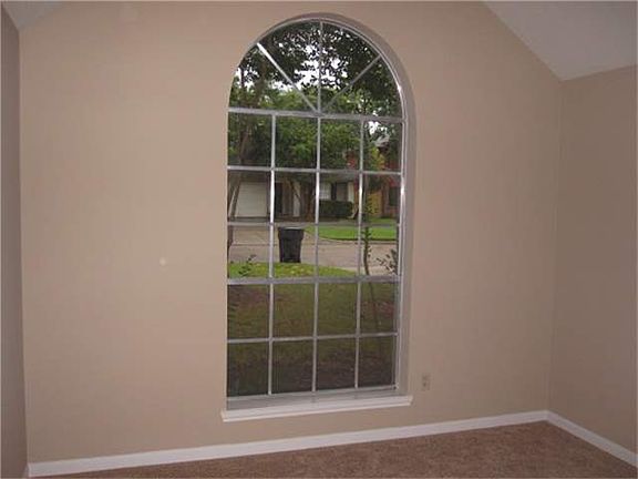 Front bedroom with great arched window to front yard