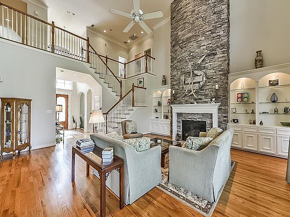 Generously sized kitchen features stainless steel appliances, kitchen aid double ovens, built in microwave, granite counter tops and tons of storage with cabinets built all the way to the ceiling.