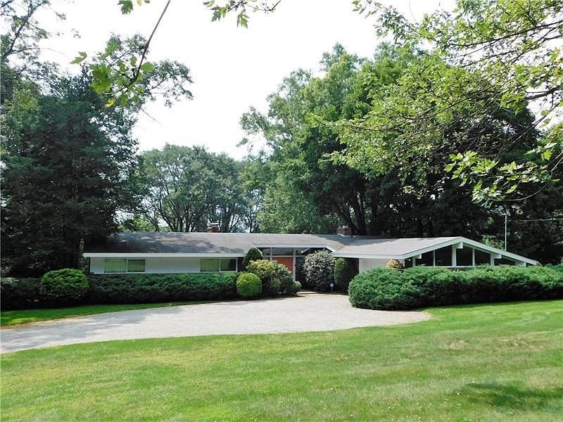 This mid-century modern, ranch home sits on 2.74 private wooded acres