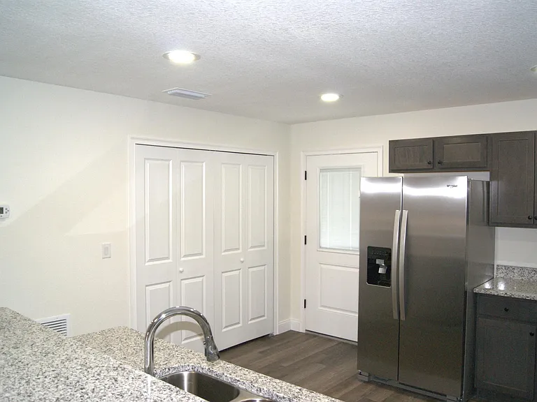 Kitchen looking toward the back door and toward the large pantry and washer/dryer spot