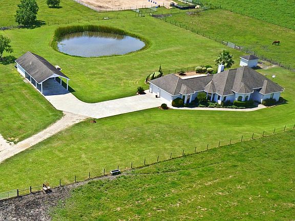  What a beautiful sight! Recently built home, a pond, pool, equestrian improvements, and private gated entry.