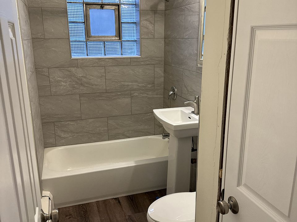 Completely remodeled bathroom with new flooring and fixtures.