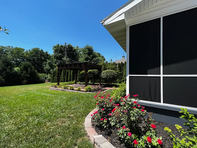 Screened in porch with privacy and super private backyard with mature landscaping and beautiful flowers and pergola patio