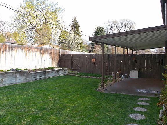 Back yard with patio and large box planter flower bed