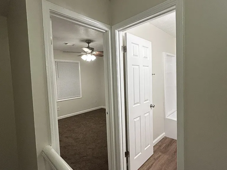 View into front bedroom and upstairs bathroom.