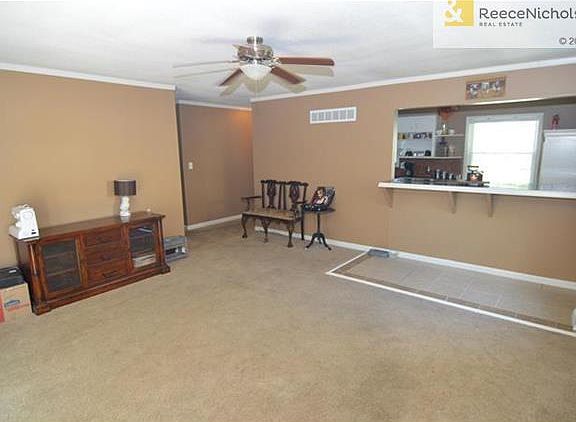 Open view from kitchen to living room with counter bar top seating