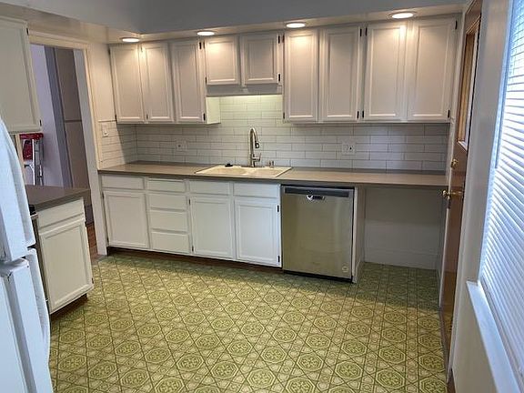 Kitchen has been updated with quartz counters, stainless dishwasher and stove, subway tile backsplash. Had to keep those retro green linoleum floors ; )