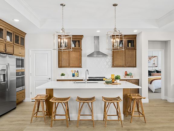 Kitchen with pendant lighting and glass upper cabinets
