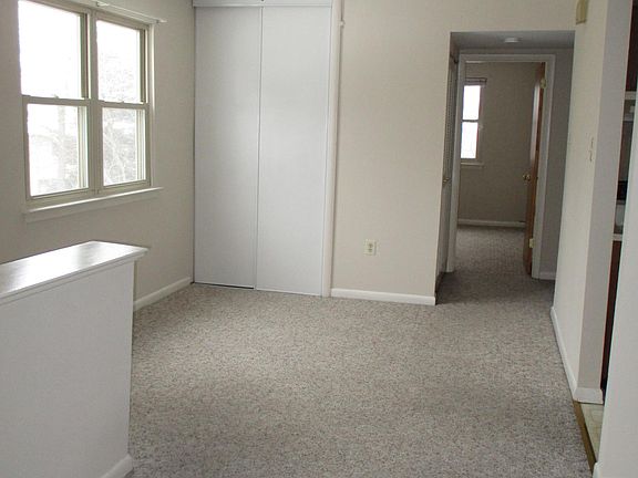 Smaller bedroom is seen at the rear of the house.