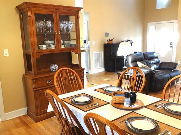 Open concept Dining has soaring ceiling, plenty of room for your table and china cabinet. Hardwood floors, light and bright, looks out to screened porch and pool.