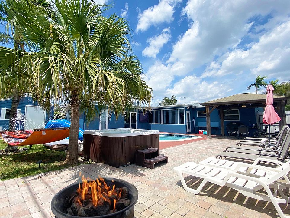 Backyard patio. Pool, fire pit, jacuzzi, hammock, water slide, bbq grill, and gazebo