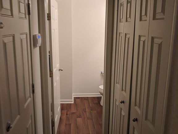 Hall to garage, coat closet, and guest restroom from entry w