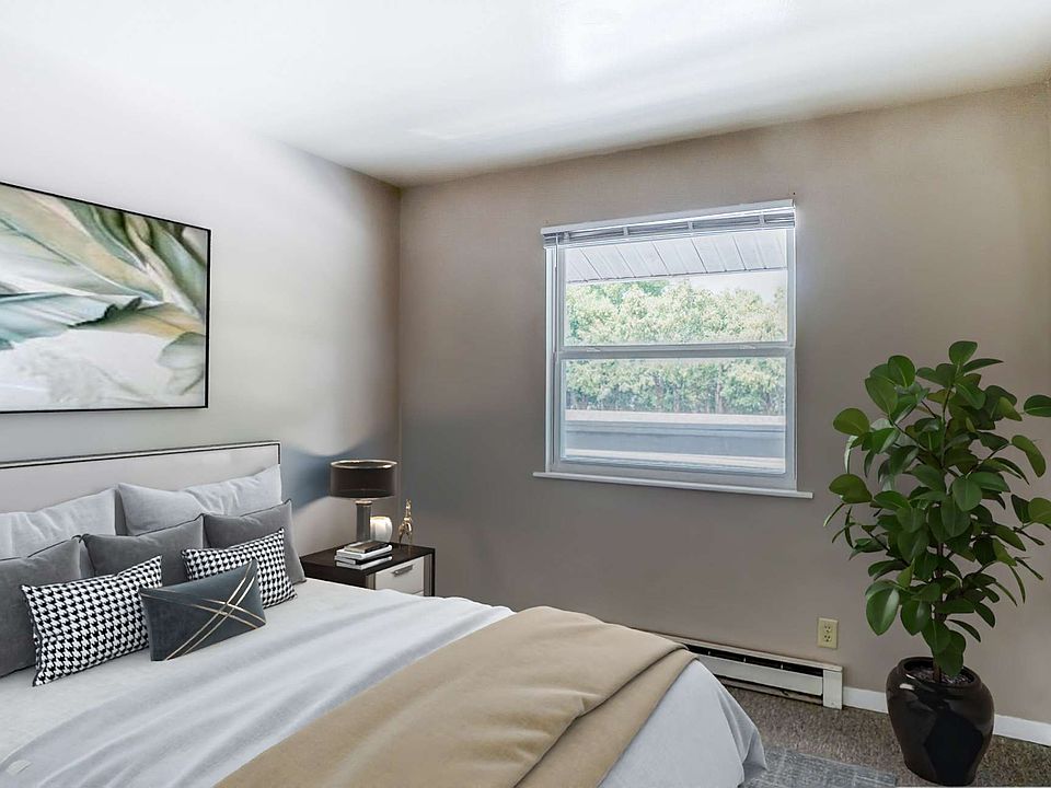 a spacious Bedroom bright walls and large window