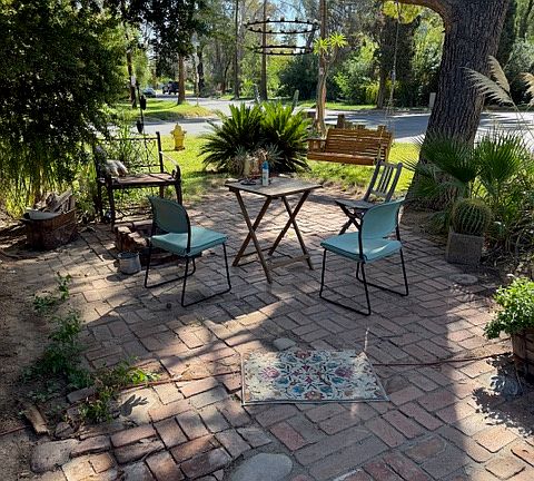 Front patio with wooden swing, fire pit, custom candle chandelier, such a great vibe out here and you will see many neighbors out walking.