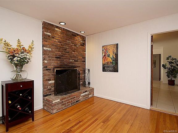den features floor to ceiling brick fireplace