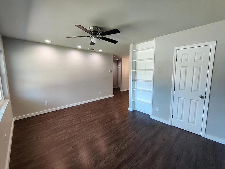 Living Room with closet and built-in bookshelf