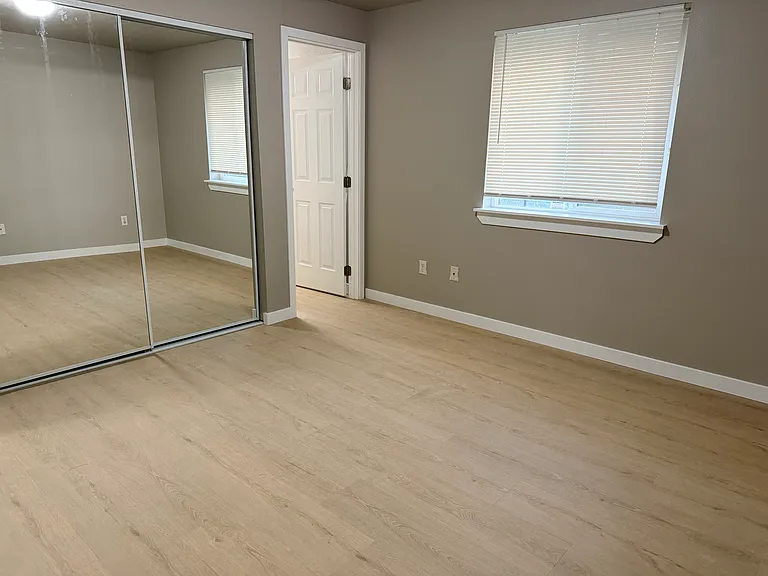 Master bedroom with mirror closet door