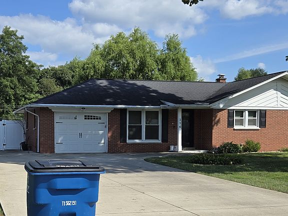 Front with Garage an Extra Parking Pad