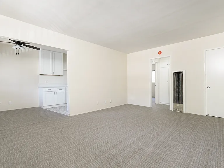 Living/dining area with ceiling fan. Living room has coat closet