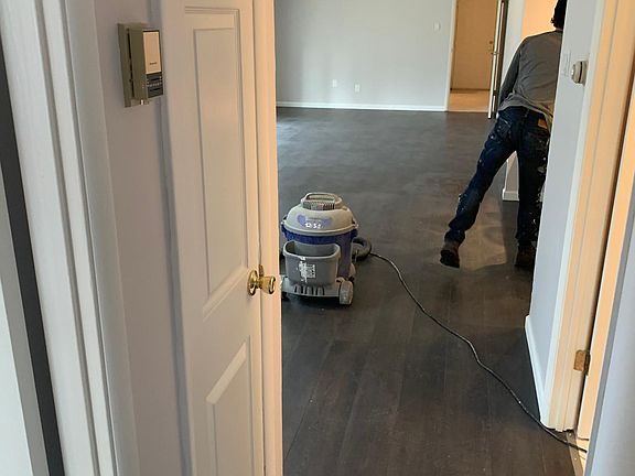 Hallway looking towards another living area/kitchen and utility room in background