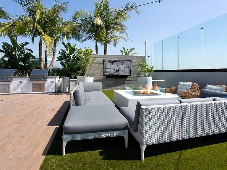 Building A rooftop lounge with grills, fireplace and seating