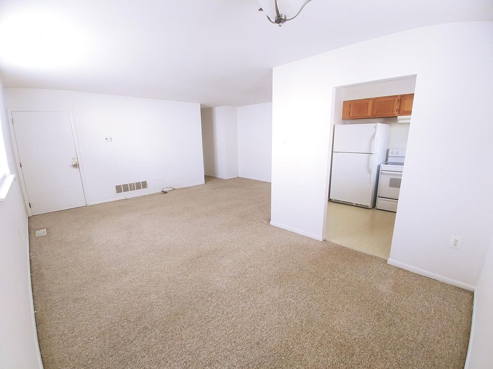 Family/Dining Room, entrance door on left, kitchen on right, hallway to closets/bedrooms in back corner