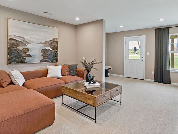 Spacious Lower-Level living room in a York II South Brook Townhome by DRB Homes, featuring modern de