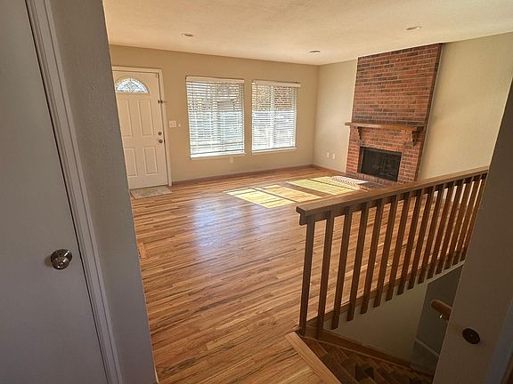 Front living area next to front door. Fireplace.