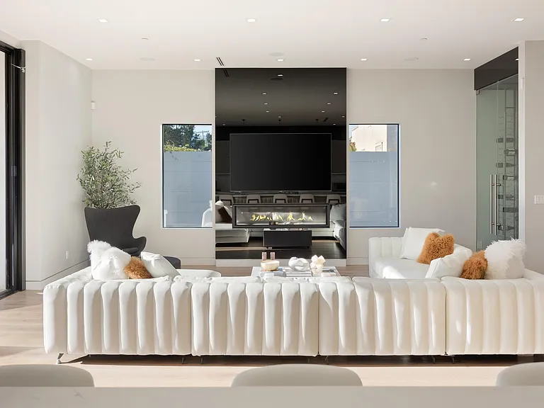 Open and elegant dining room with modern art
Living room with flat screen tv and modern fireplace