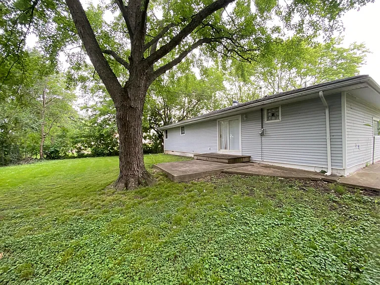 Large fenced backyard with patio