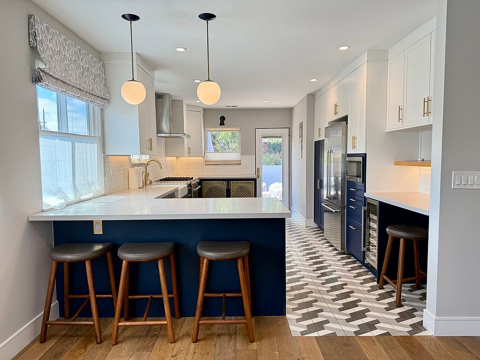 Chef's kitchen, view from living/dining space. Counter seating, custom lighting, desk area to right. Stools included if desired!
