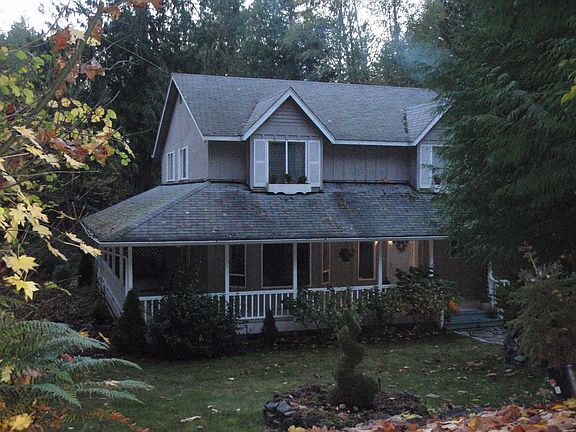 covered porch wraps around to the back
