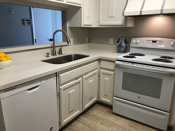 Kitchen with new counter tops, sink and faucet. Dishwasher and range are less than 5 years old, microwave is brand new