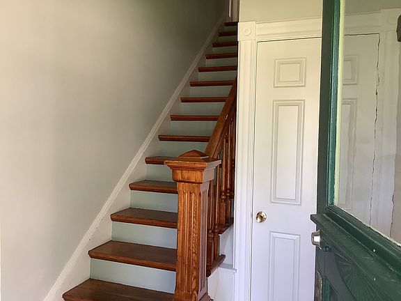 Front entry, stairs up to the apartment stair hall. Coat closet at entry.