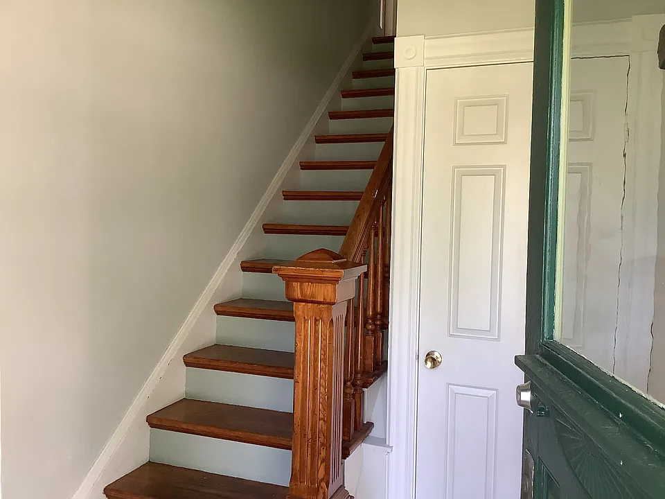 Front entry, stairs up to the apartment stair hall. Coat closet at entry.