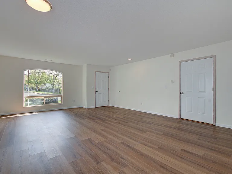Open living room with garage and front door