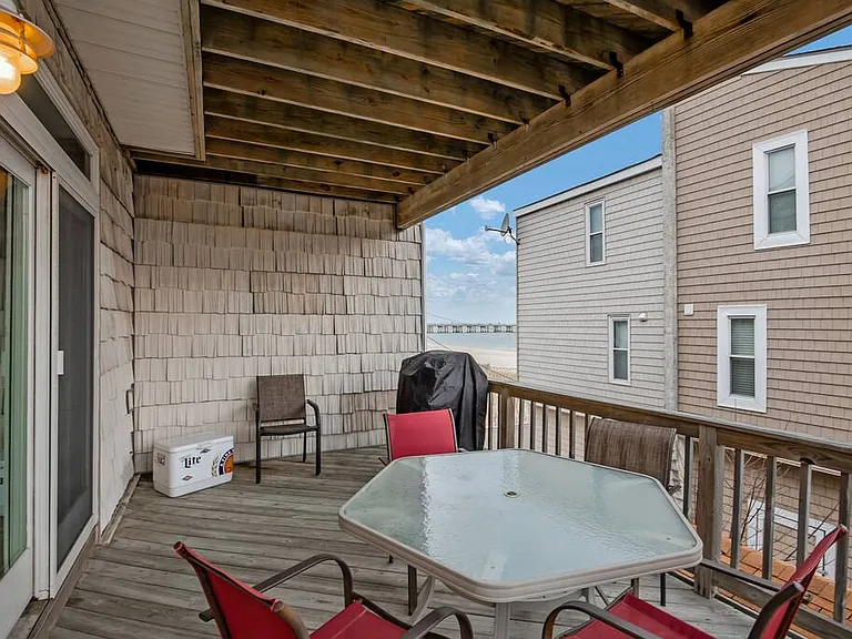 Balcony off of living room with a gas grill for you to enjoy.