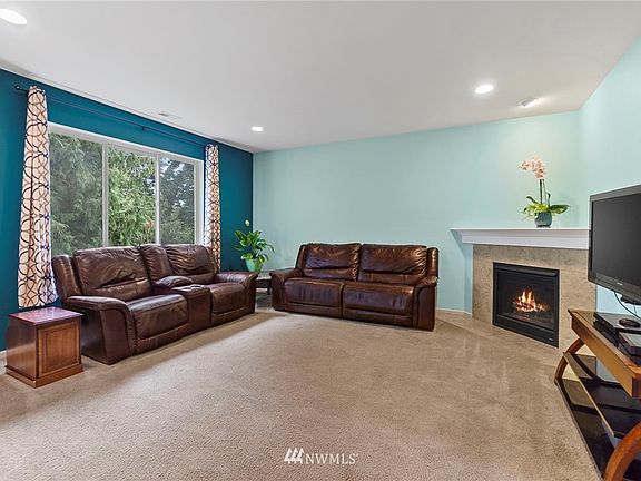 Large windows bring in tons of natural light and you have views of the terraced backyard and trees!