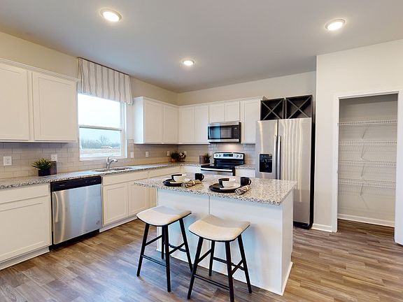 Rosella Kitchen with white cabinets and granite countertops